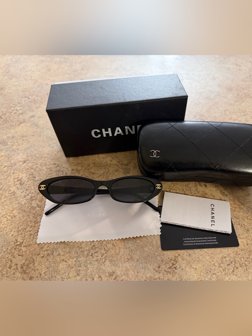 CHANEL Black Oval Sunglasses with Gold CC Accent